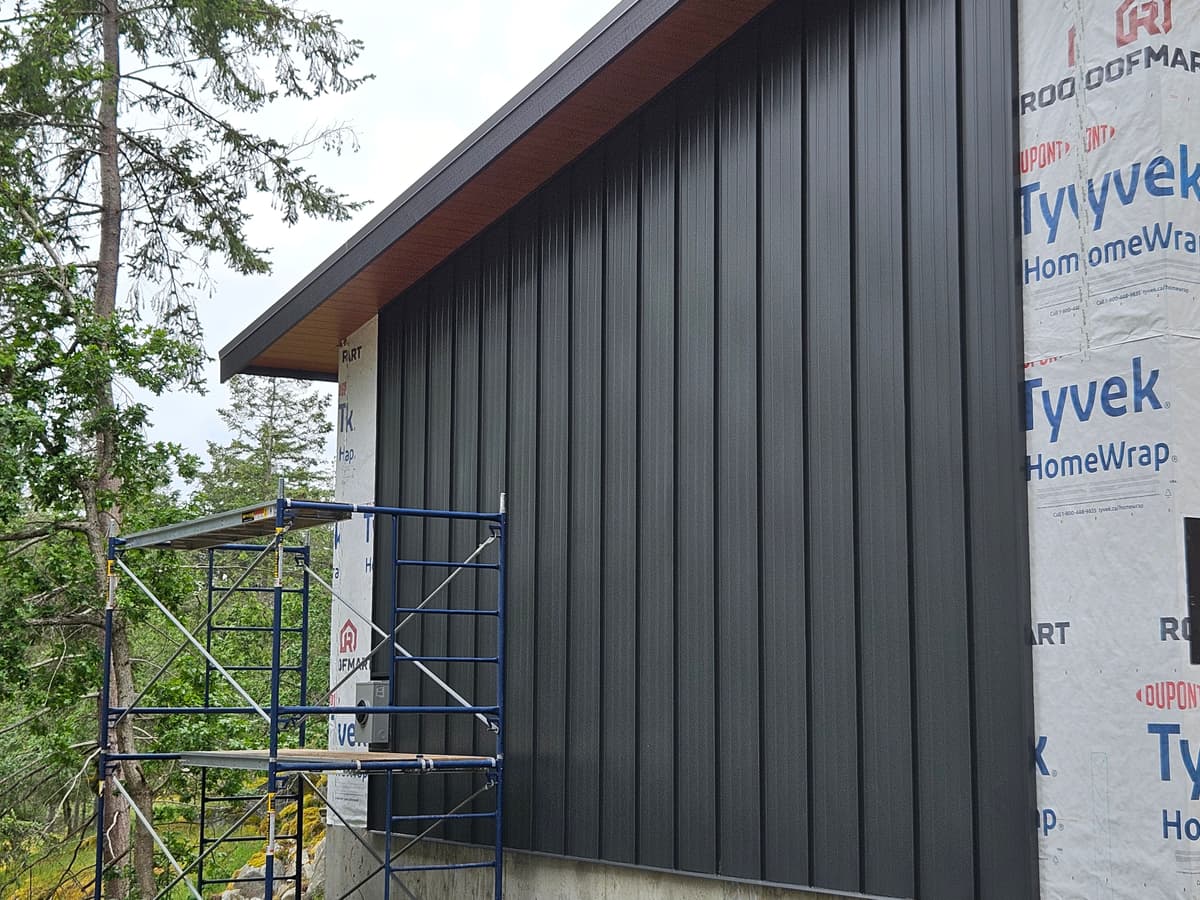 Metal siding installation with scaffolding on custom home